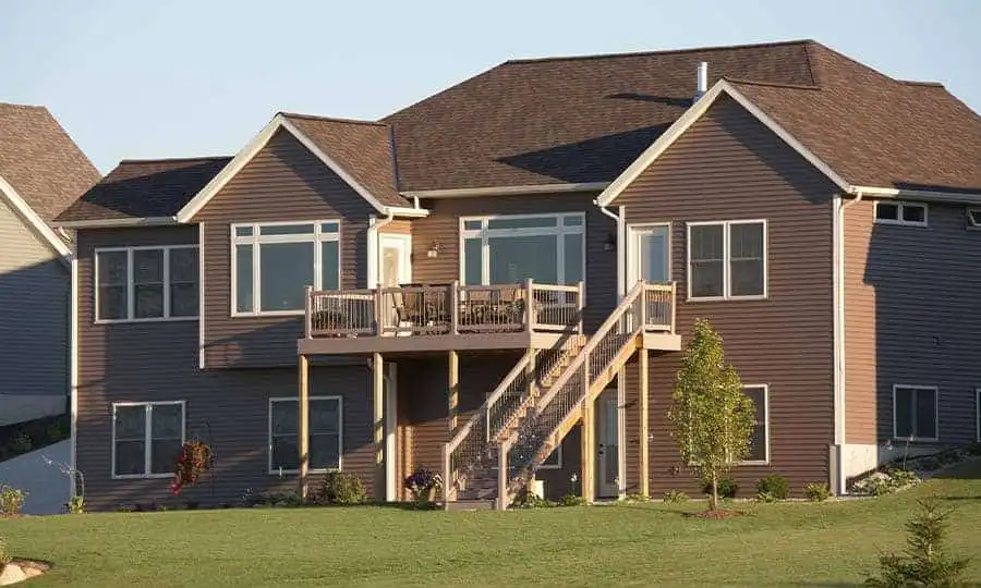 Dark horizontal vinyl siding on elevated residential home